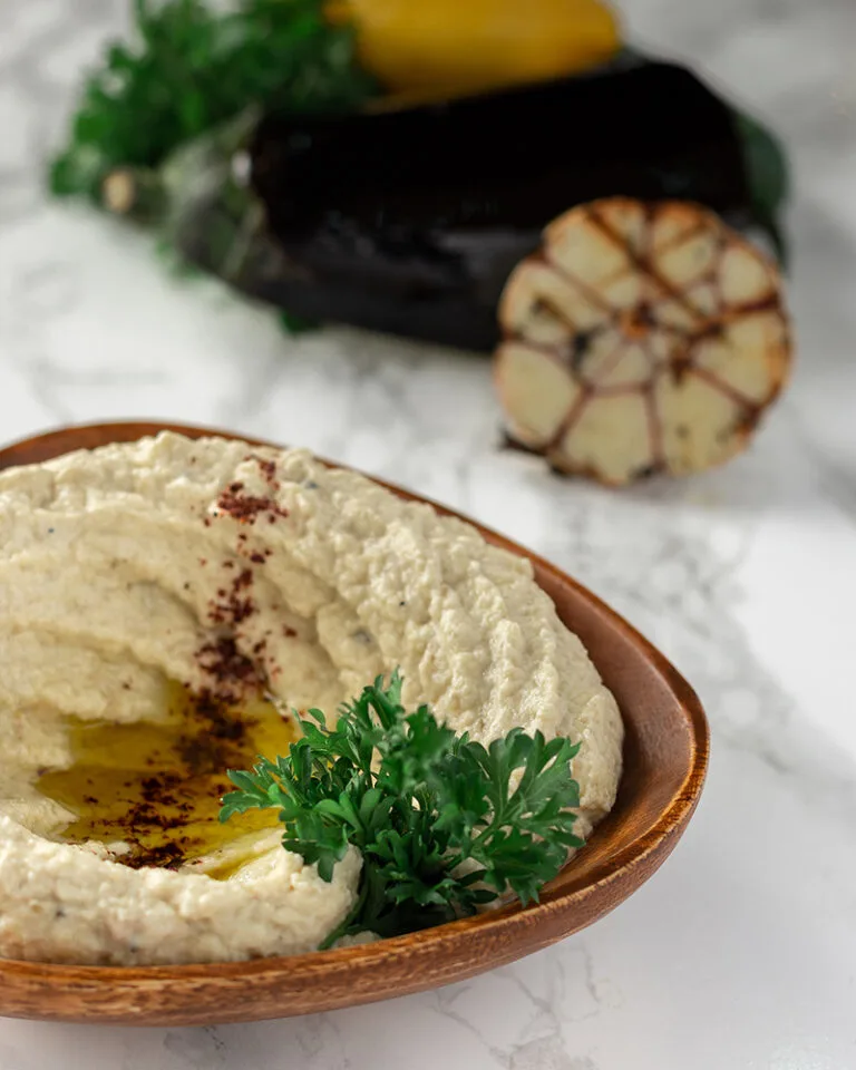 Hummus with garlic Ottawa served in a bowl with olive oil and pita bread