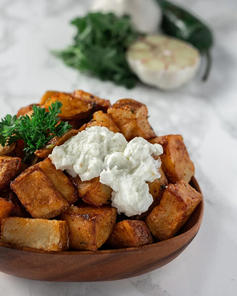 Roasted potatoes Ottawa served with garlic sauce and fresh herbs