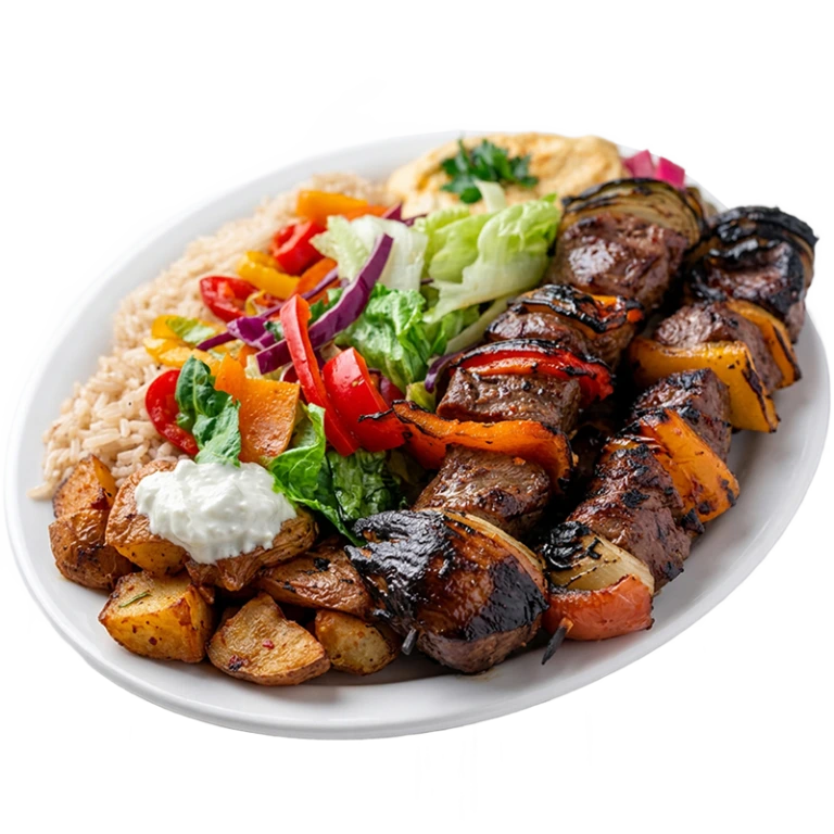 Beef kabab platter with grilled marinated beef cubes, peppers and onions on a skewer, served with rice and roasted potatoes at Shawarma Palace