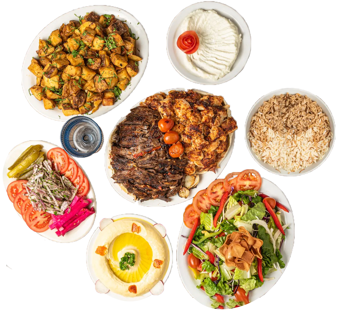 Family shawarma platter spread with chicken and beef shawarma, rice, roasted potatoes, fresh salad, hummus, pickles and garlic sauce from Shawarma Palace