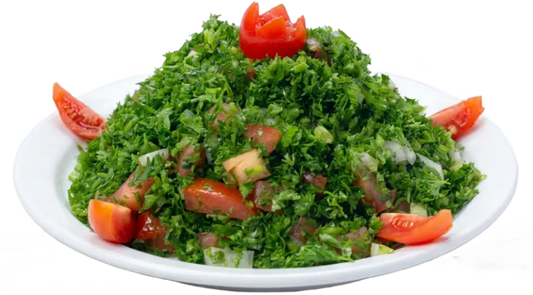 Fresh tabbouleh salad with chopped parsley, tomatoes, onions and bulgur, garnished with tomato slices at Shawarma Palace